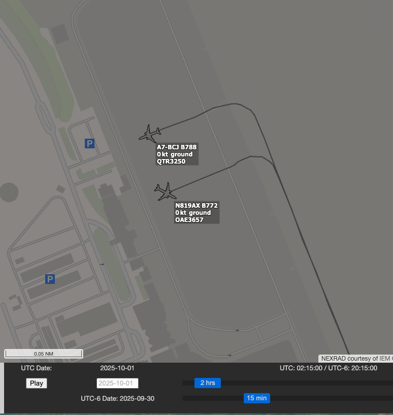 Replay of Doha International Airport at 02:15 UTC on 1 October 2025, showing two aircraft parked a few dozen metres apart on the same apron: A7-BCJ, a Boeing 787-8, and N819AX, a Boeing 777-200, both stationary at 0 knots.