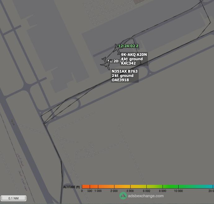 Replay of Kuwait International Airport at 12:24 UTC on 26 January 2026 showing two aircraft close together on the apron: 9K-AKQ, an Airbus A320neo under the callsign KAC342, and N351AX, a Boeing 767-300 under the callsign OAE3918.